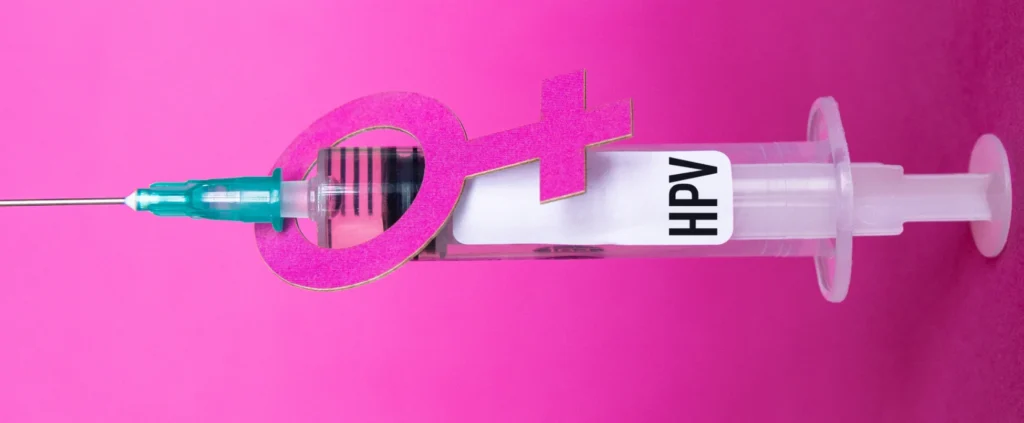 Vacina contra HPV simbolizada por seringa e símbolo feminino para prevenção do câncer de colo de útero.