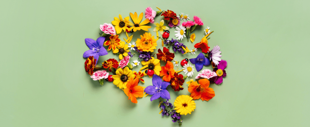 Representação artística de mente saudável e autocuidado com flores em formato de cérebro.